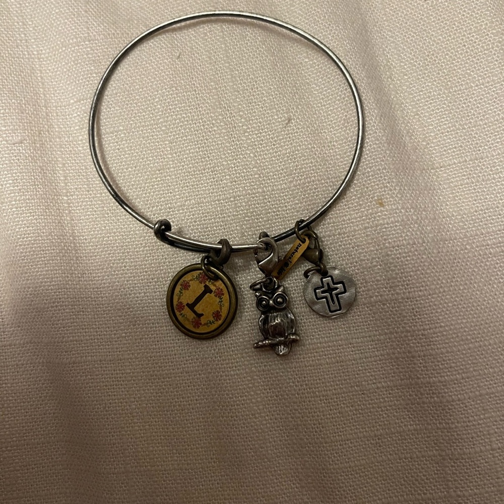 Rustic looking adjustable bracelet with removable charms.